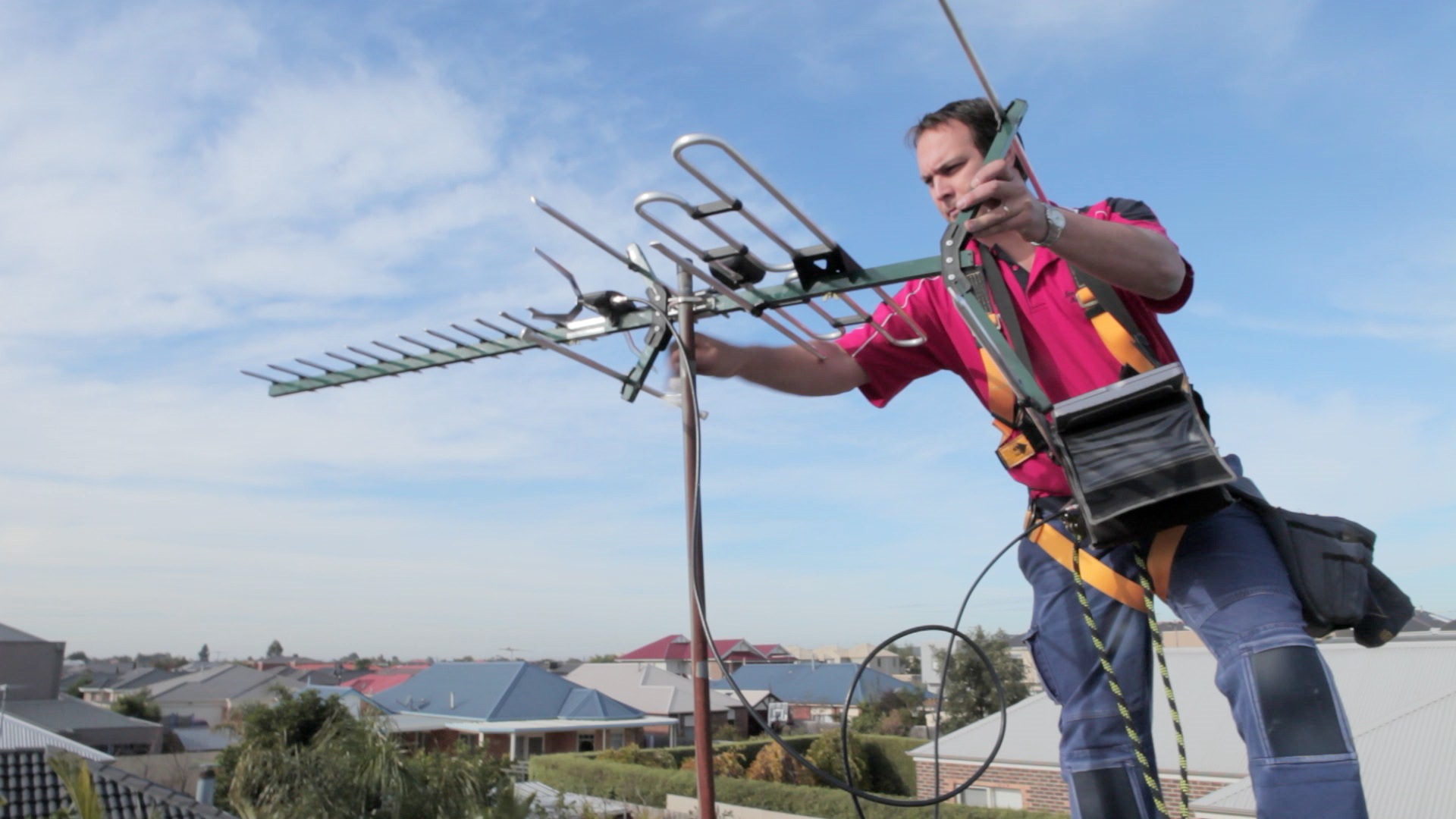A picture of a man installing an aerial in Eastbourne