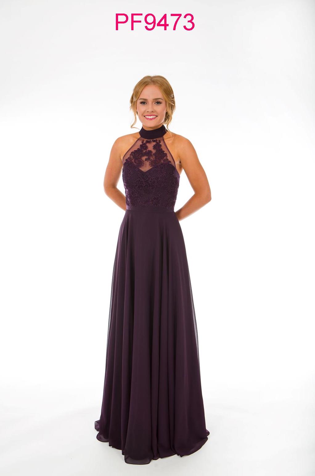 Prom girl wearing damson coloured gown with racer neck, lace bodice and full chiffon skirt.