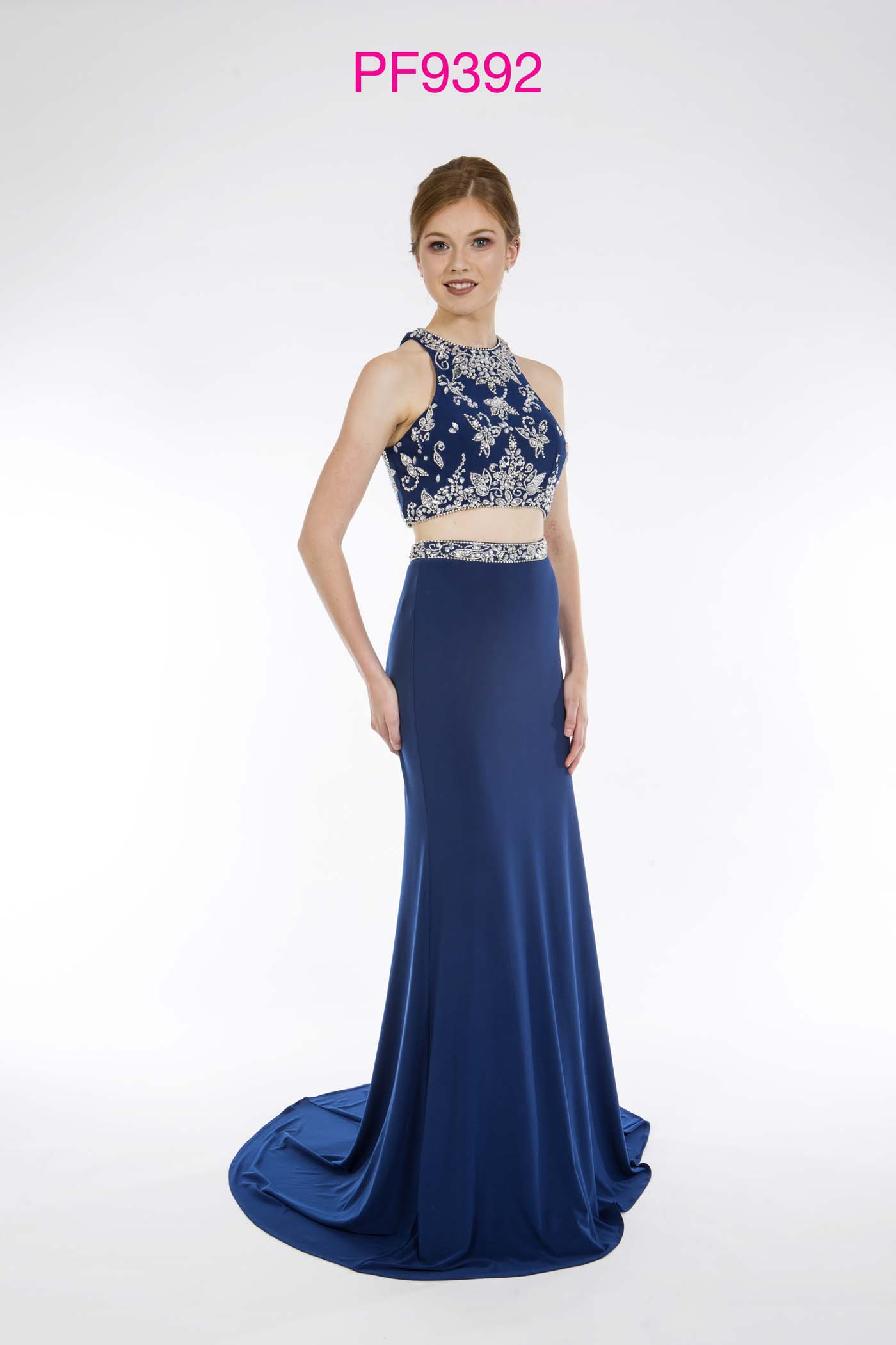 Prom girl wearing navy jersey 2 piece gown with silver beaded top and figure hugging skirt with train