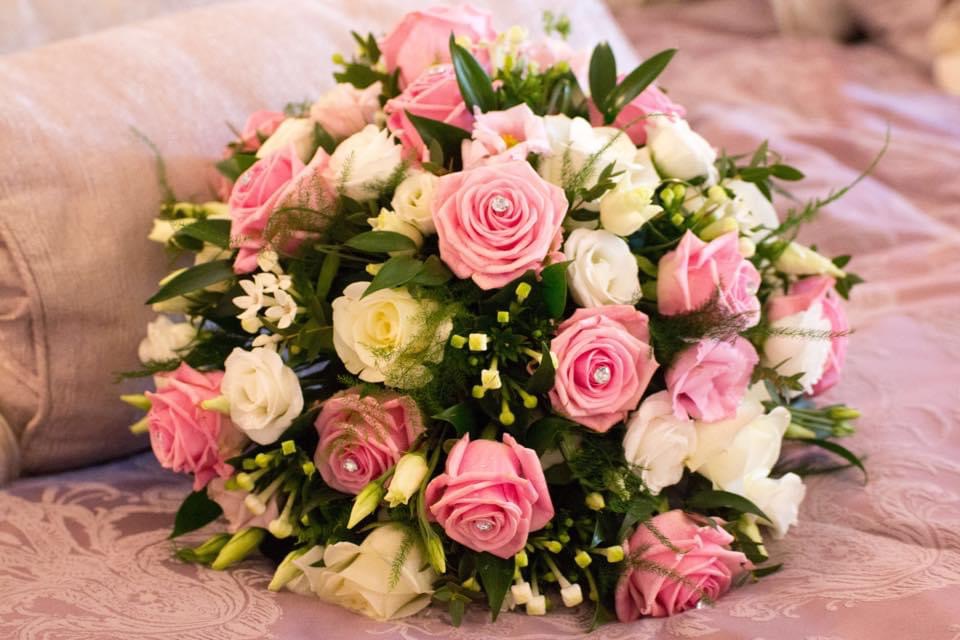 A hand tied posy with pink and white roses