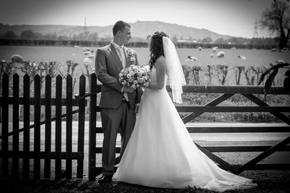 A bride and groom taking a moment to themselves looking over open fields