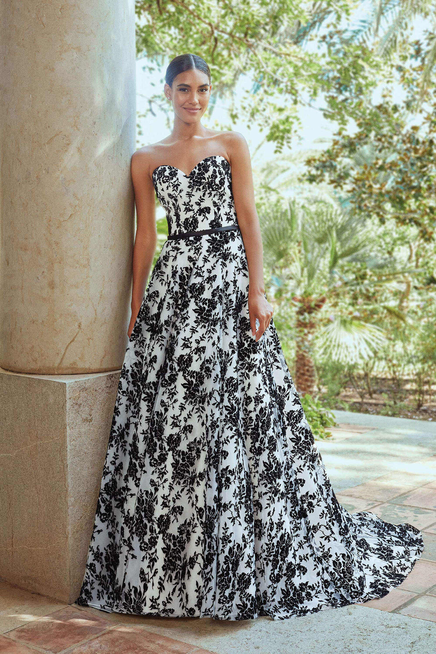 Bride wearing black and ivory velvet embossed princess gown with sweetheart neckline and tiny satin belt at waist.