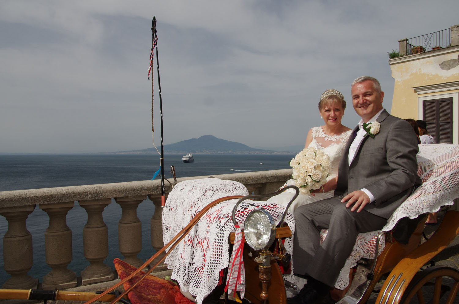 Bride and Groom in a horse drawn carriage on the way to their wedding.