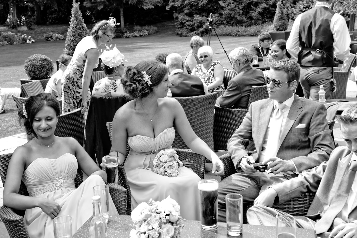 Wedding guests enjoying the summer sunshine together.