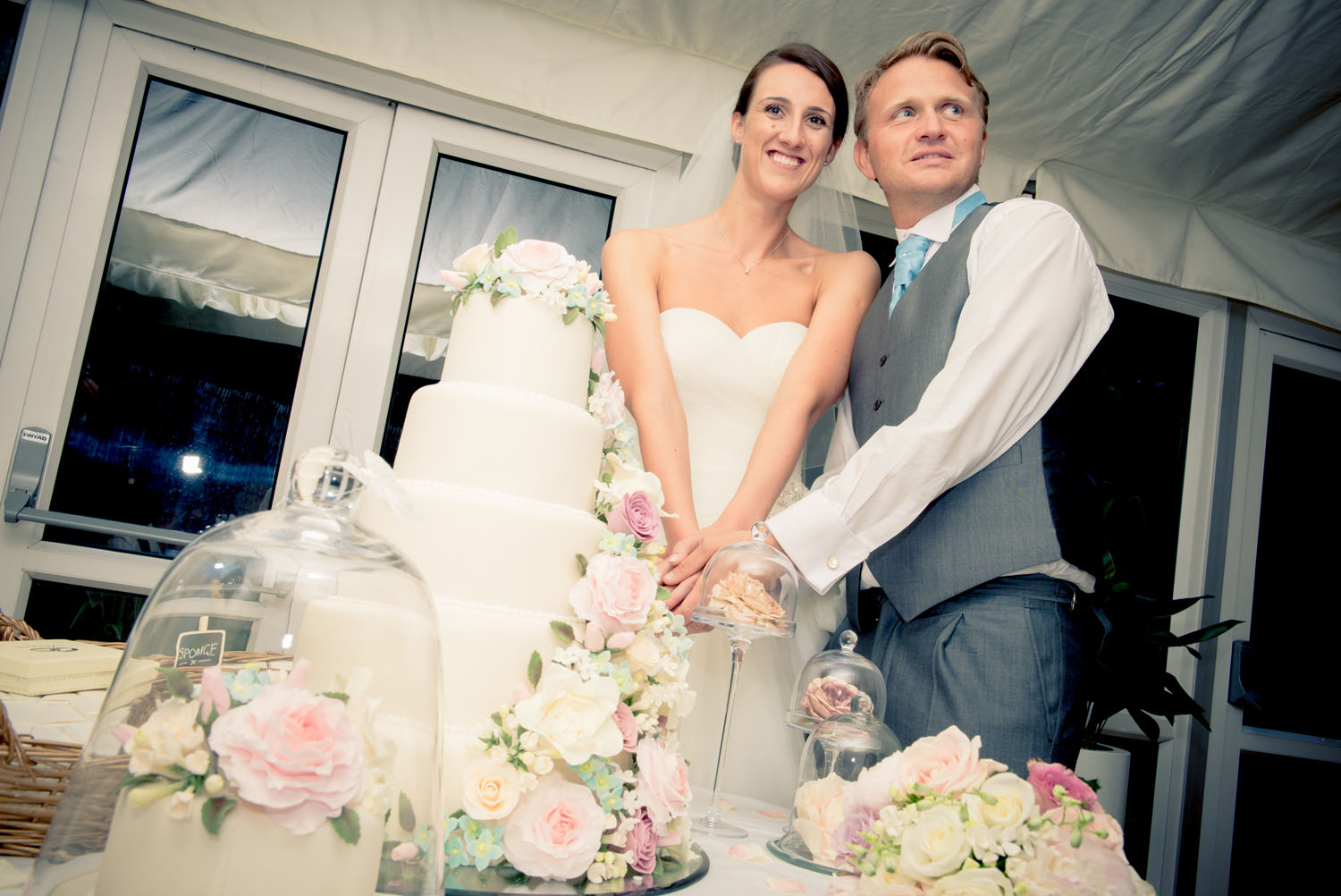 Bride an groom cutting their 2 tier cake.
