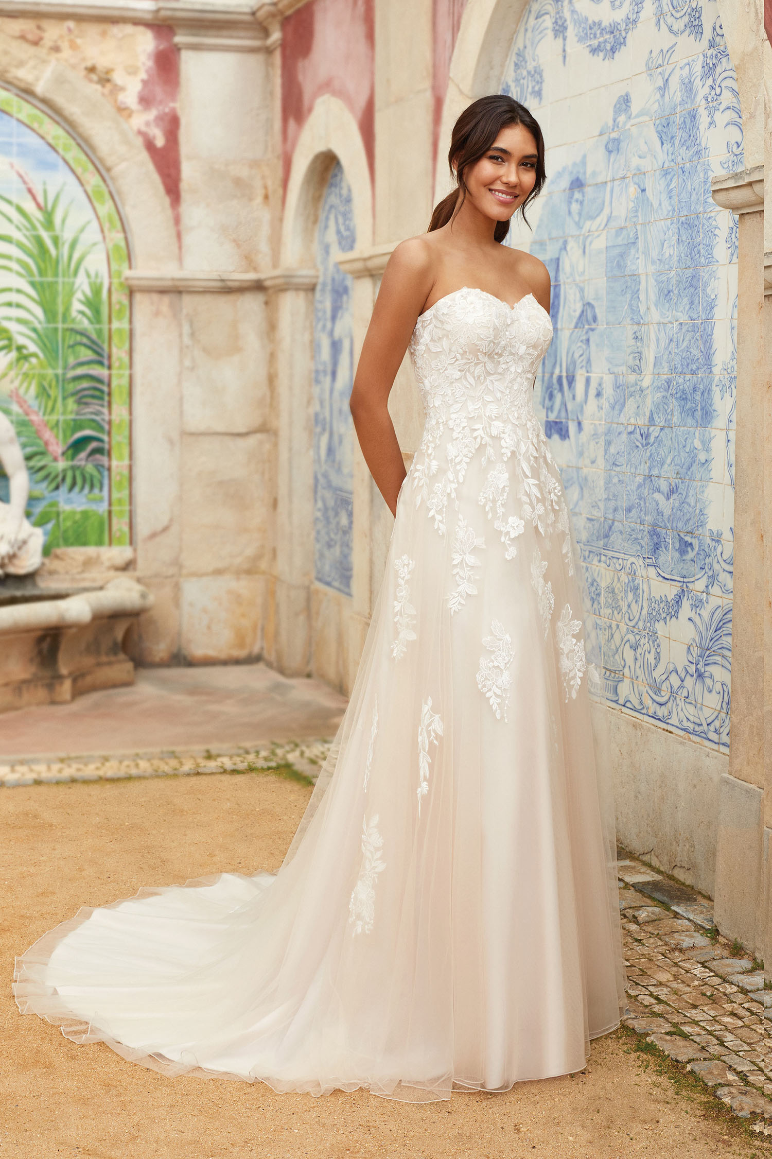 Bride wearing simle fit and flare gown with beaded motifs