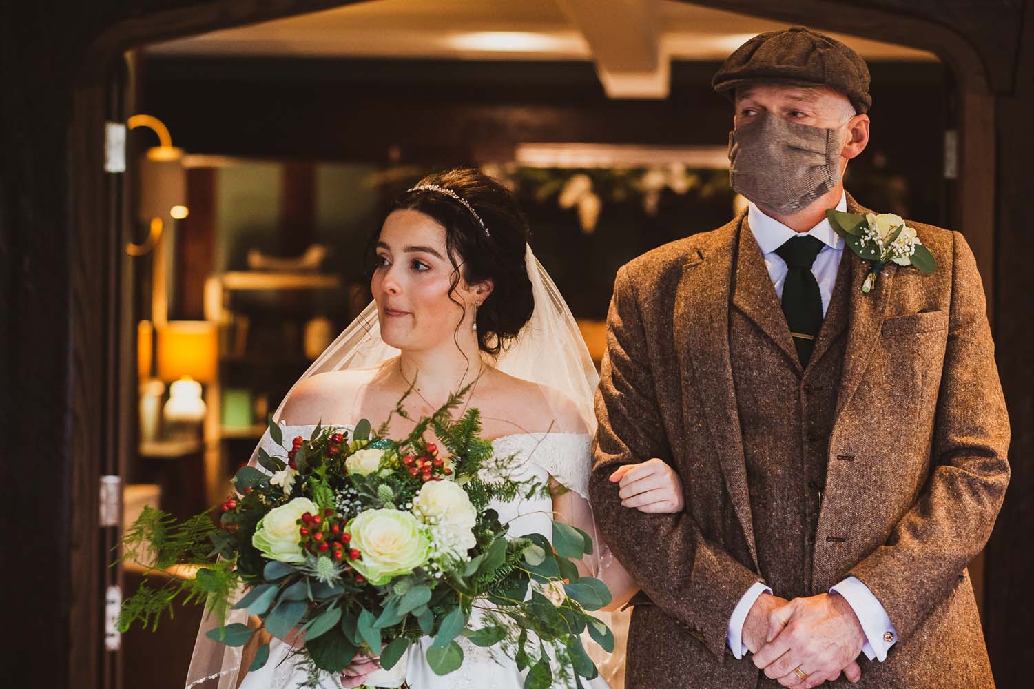 Bride walking down the aisle with her dad at her Peaky Blinder themed wedding