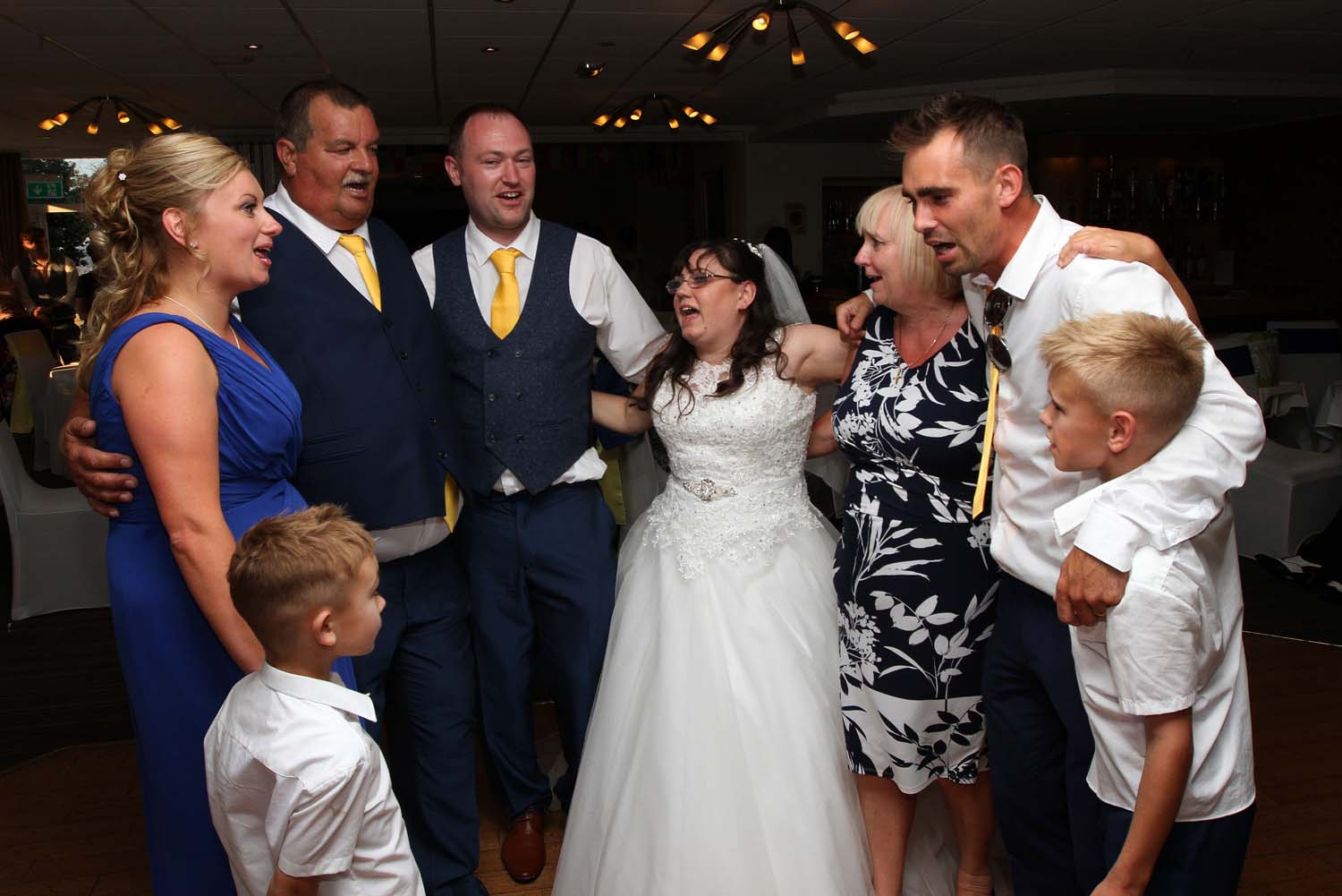 A wedding couple enjoying a sing along with heir family on the dancefloor