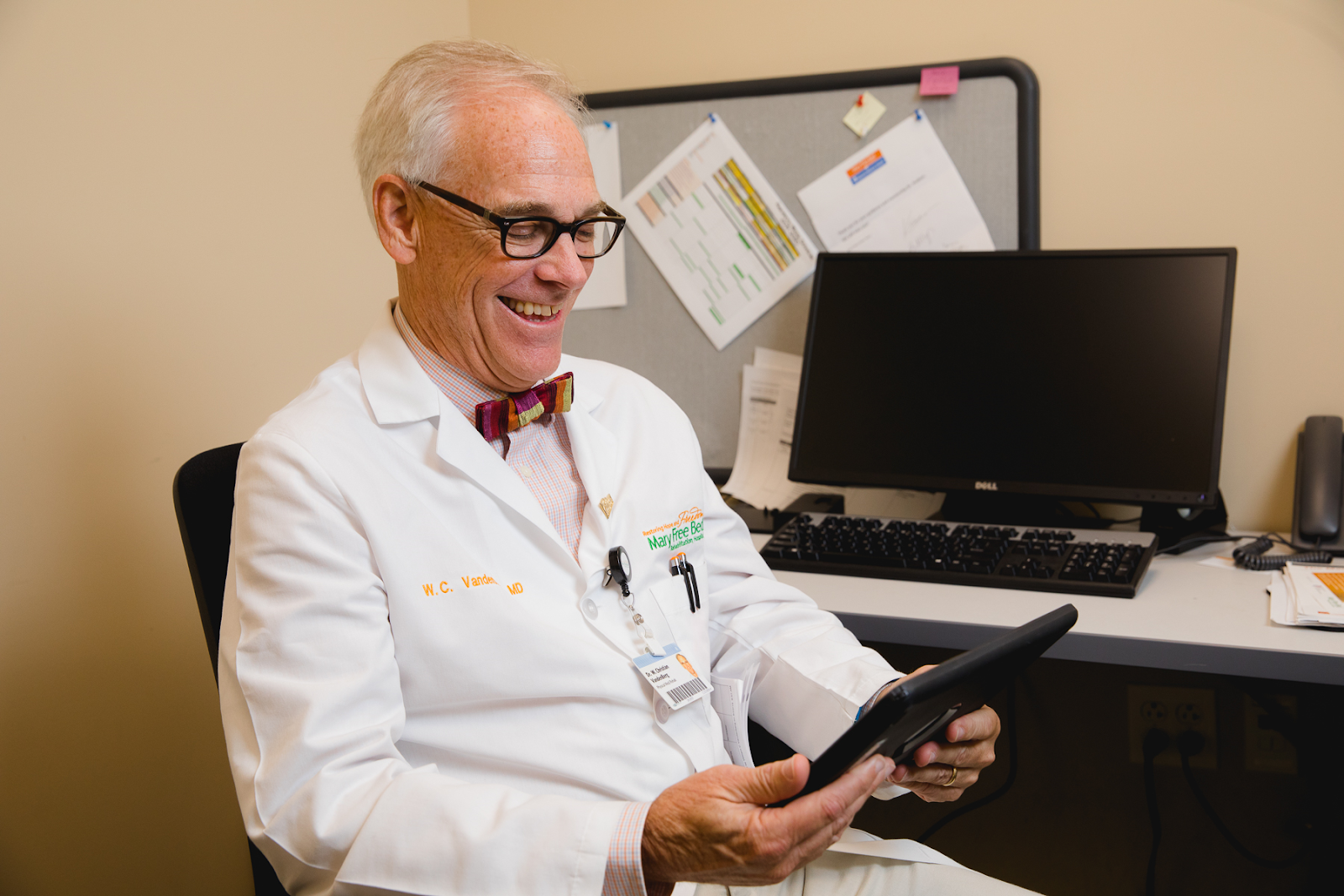 A doctor communicates virtually with a patient via webcam.