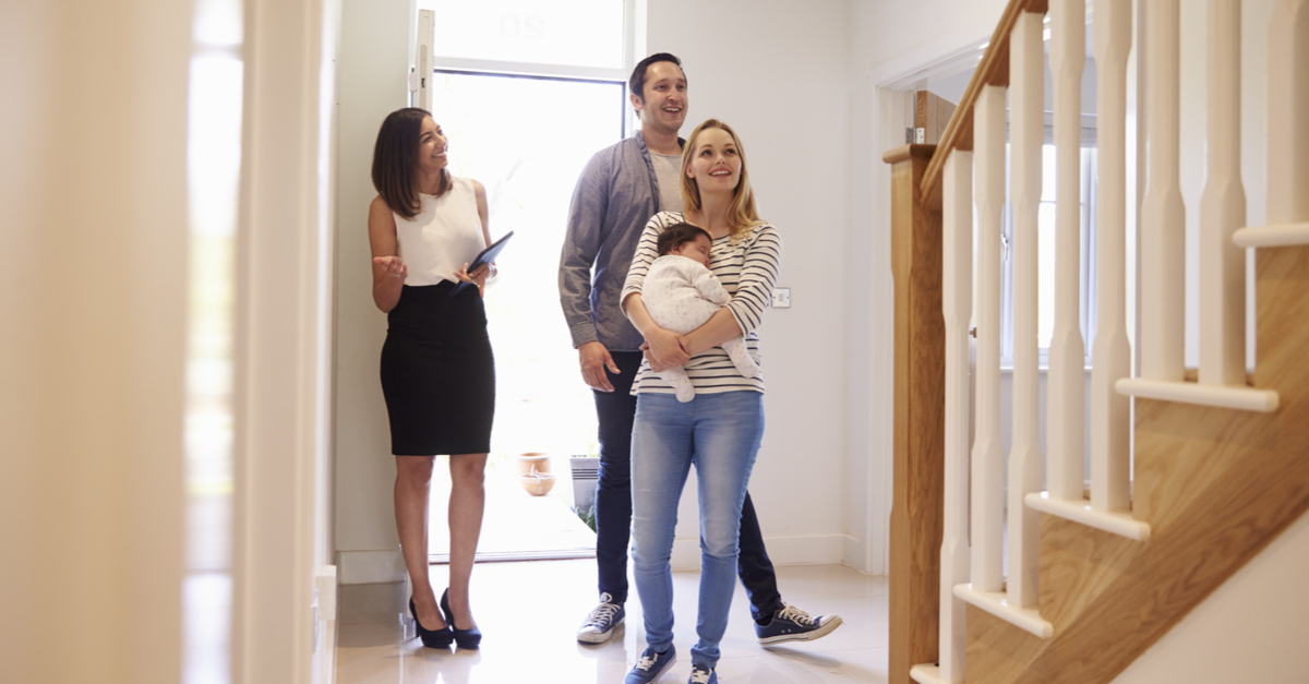 new family looking at new home with baby