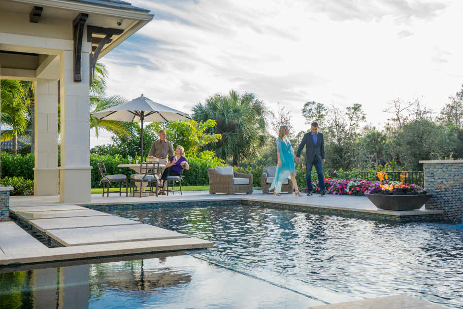 couple walking around pool