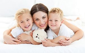 Young mom with two small children, all happy because of new allergy drops.