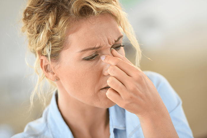 Woman suffering from sinus pain needs relief today!