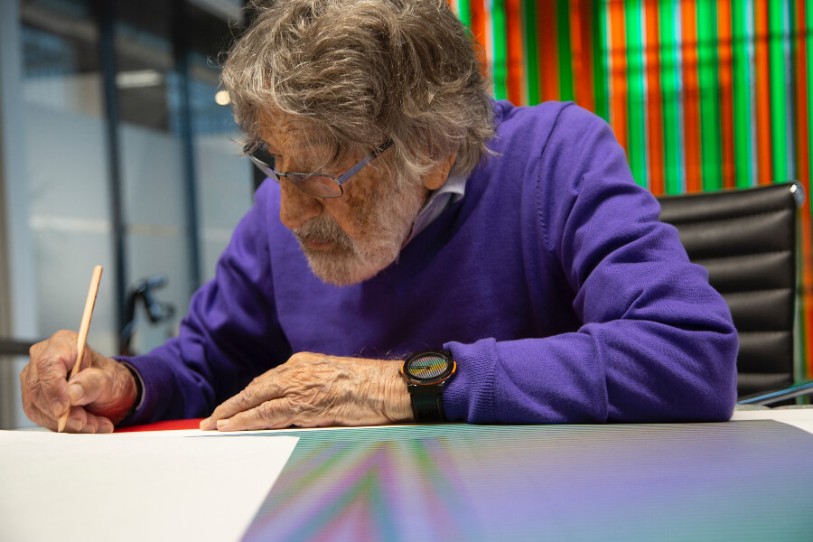 Carlos Cruz-Diez signing an artwork in his workshop, Paris, France, 2018