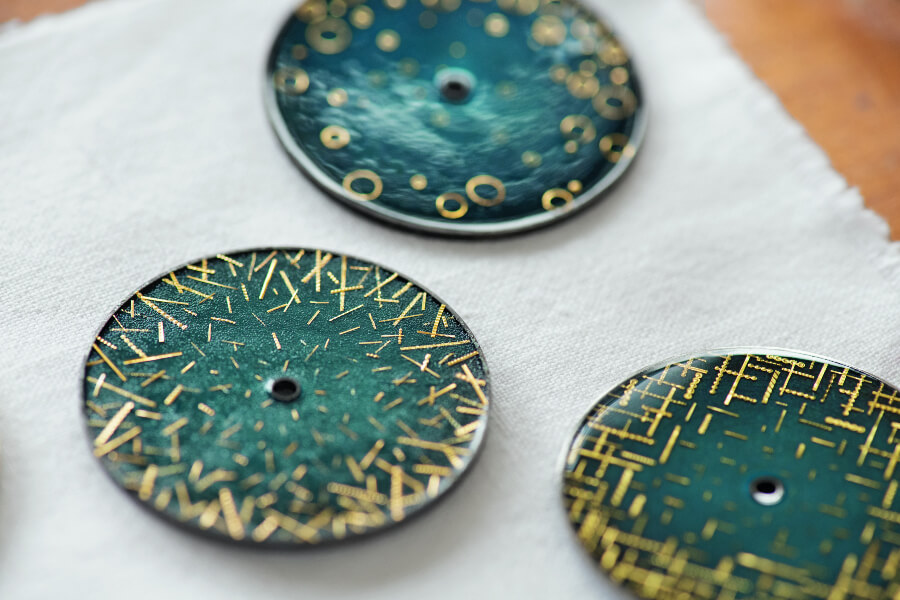 Trilogy of “Grand Feu” enamel dials crafted by Anita Porchet and decorated with gold spangles over a century old