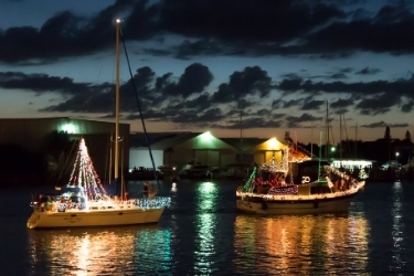 Boats decorated with Christmas lights having a parade