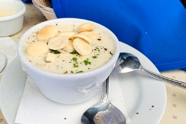 New England Clam chowder with crackers on top