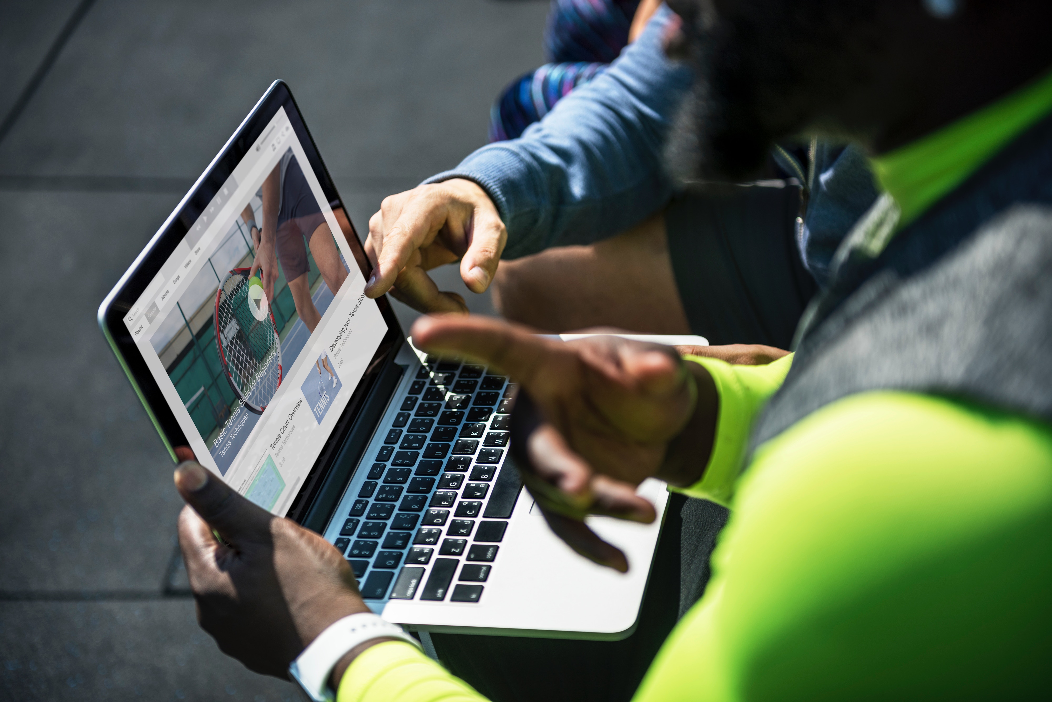 2 people working on a project with a laptop