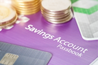 Savings Account Passbook with coins and credit cards