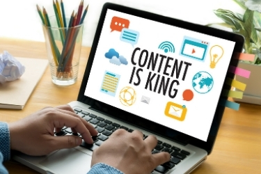 Laptop with "Content Is King" in the screen