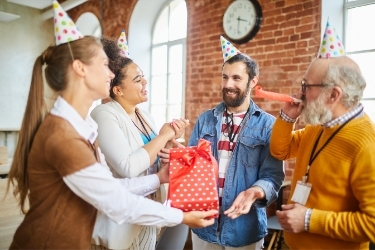 People celebrating a birthday at the office