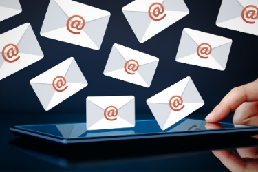Email Marketing Campaign - Email letters coming out of a tablet