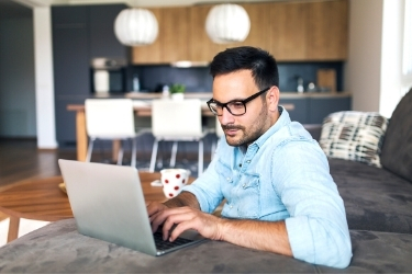 Man working on his laptop remotely from his home