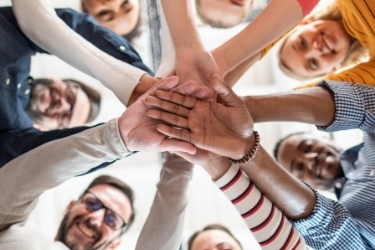 Teamwork - Group of people putting their ands together