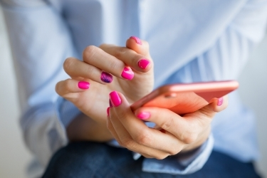 Woman's hands holding a mobile phone