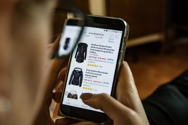 Person shopping for clothes on a mobile e-commerce website
