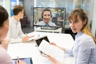Small team working together with a remote coworker