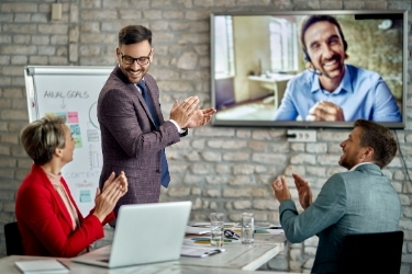Team applauding to a remote coworker
