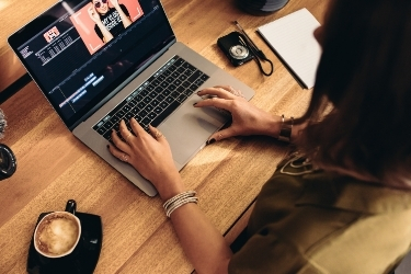 Woman editing a video on her laptop