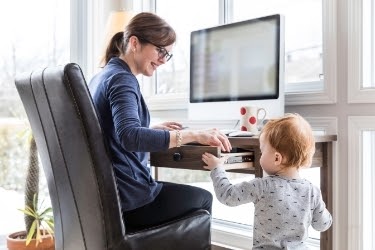 Woman working from home with a kid
