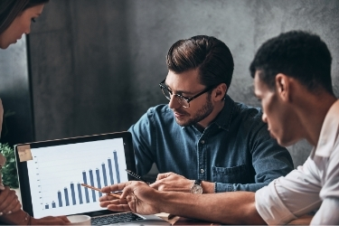 People studying a growth graphic