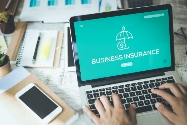 Searching for Business Insurance at a laptop