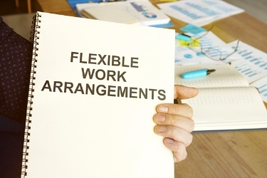 Hands holding a "Flexible Work Arrangements" book