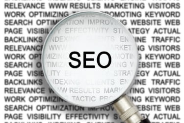 Magnifying glass going through a lot of text with the word SEO