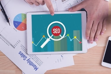 SEO image in a tablet with graphics of Monthly sales