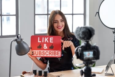 Influencer recording herself asking for likes & subscribes
