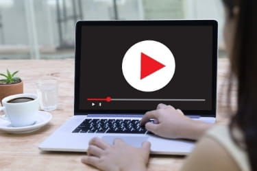 Laptop open with a video