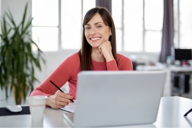 Woman sitting in front of her laptop working
