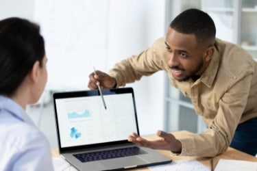 Man explaining a solution with a laptop