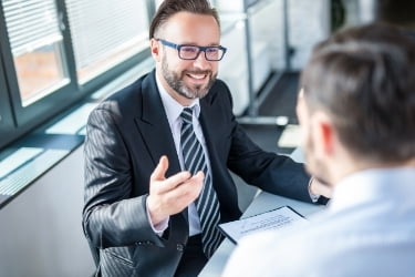 Happy business man talking to his client
