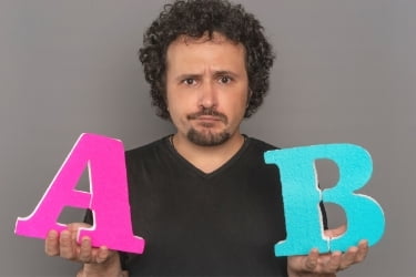 Man holding a letter A and B