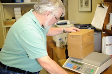 Worker weighing a box