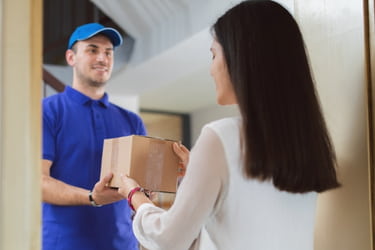 Man delivering a box to a woman