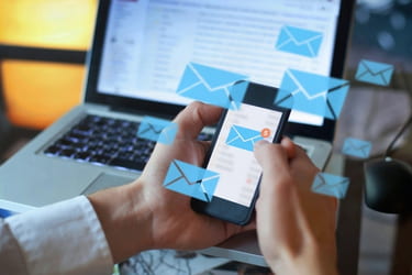 Man holding his phone checking emails