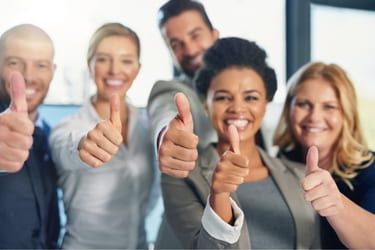 Happy team giving thumbs up