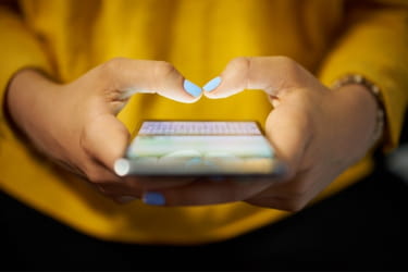 Woman engaging with social media through her mobile